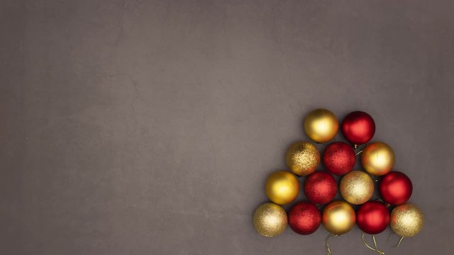 Christmas gold and red balls make Christmas tree with star on the top - Stop motion 