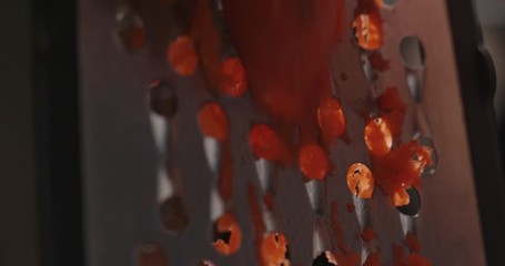 Chef grinding carrot on grater close up, macro shot of cooking process, red epic, dramatic look, slow motion