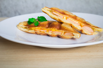 Sandwiches, sausages, ham, cheese on a wooden table
