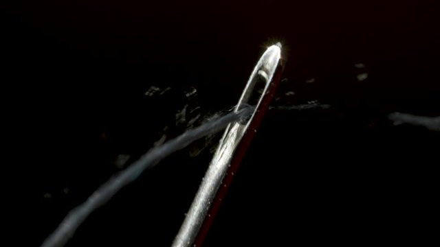 Threading through the eye of a needle in macro
