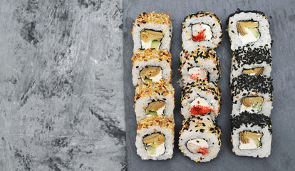 Japanese rolls on stone background.