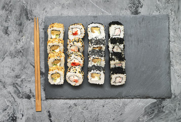 Japanese rolls on stone background.
