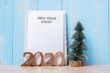 2020 New Year Start word on notebook and wooden number. Goal, Resolution, Plan, Action and Mission Concept