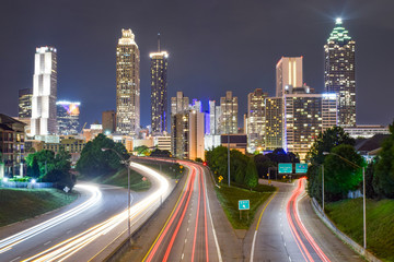 Fototapeta na wymiar Skyline of Downtown Atlanta and Blurred Highway Traffic at Night - Atlanta, Georgia, USA