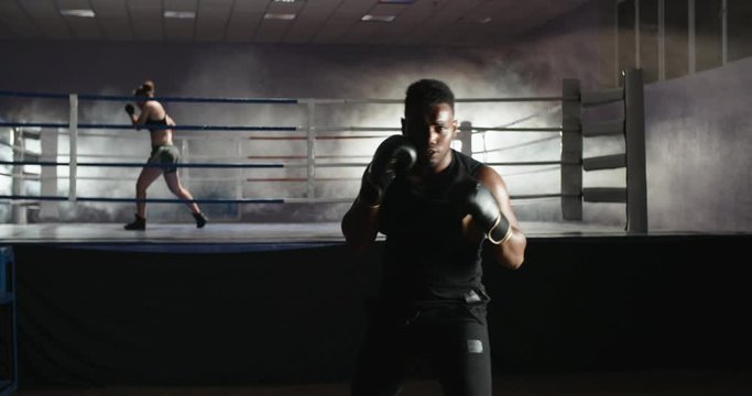 Two athletes working in a gym, keeping fit and preparing for a sparring - active way of life, sports, fitness concept 4k footage