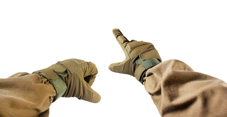 Isolated photo of first person view soldier hands in tactical gloves pointing gesture.