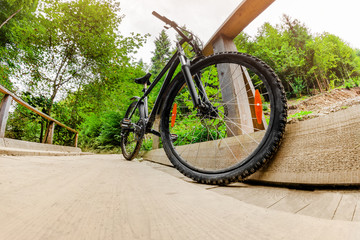 Touring bicycle standing in the forest wooden bridge.