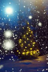 Fototapeta na wymiar Merry Christmas! Christmas tree outside snowfall in the moonlight. Beautiful Christmas background. Fairy tale