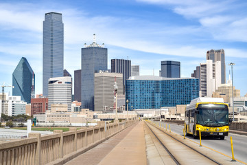 Fototapeta na wymiar Public Bus on Elevated Highway with Downtown Dallas in the Background - Dallas, Texas, USA