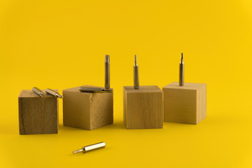 Interchangeable screwdriver set with different types of metal steel heads and bits. Isolated on yellow background.