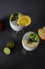 Healthy chia pudding in a glass with fresh fruits and honey