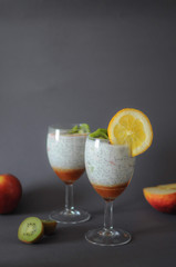 Healthy chia pudding in a glass with fresh fruits and honey