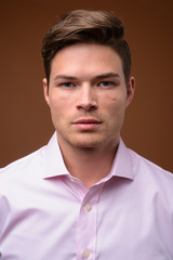 Obraz premium Studio shot of young handsome businessman with pink shirt