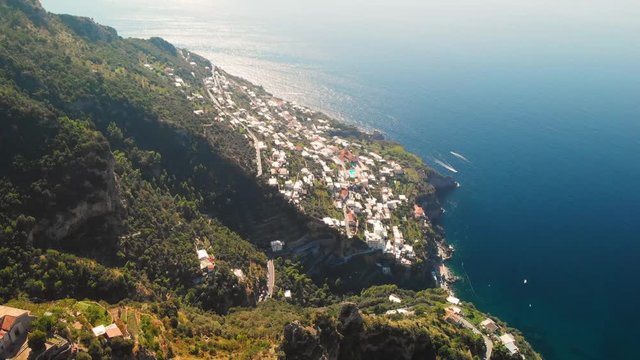 Small town on Amalfi coast, view from Path of the Gods hiking trail - aerial tilt up