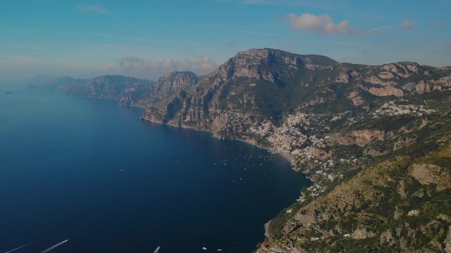 Hiking route on Amalfi coast (Path of the Gods) and Positano in the distance - aerial pan