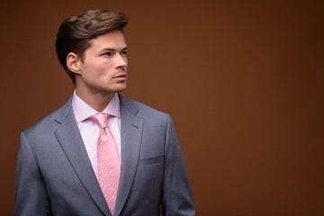 Studio shot of young handsome businessman in suit