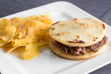 arepa with meat and fried green banana