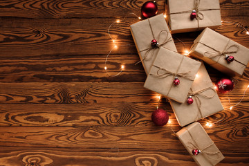 Christmas composition. Gifts, red decorations, Christmas balls, Christmas candy and garland on a wooden background. Christmas, winter, new year concept. Flat lay, top view, copy space