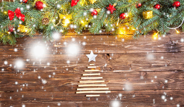 Christmas background with fir tree and decoration with Christmas tree for dry sticks on dark wooden board