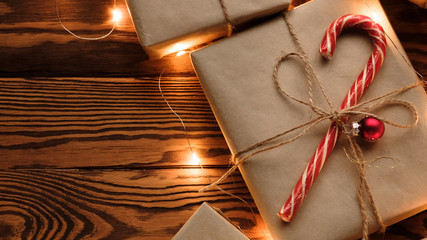 Christmas background with decorations and gift boxes on wooden table. Flat lay, top view. Christmas composition