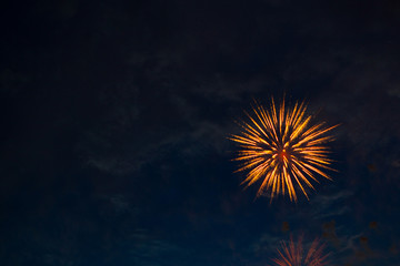 Fireworks in the evening sky with majestic clouds, long exposure