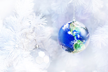 close up decorated Earth ornament on white christmas tree with blurred background, Gift earth a great christmas concept, Elements of this image furnished by NASA