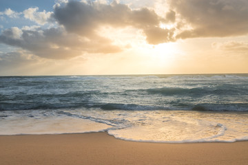 Fototapeta na wymiar Sunrise over the ocean on the beach