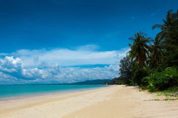 Pristine white sandy beach with aqua blue sea in Khao Lak close to Phuket Island on the Andaman coast,  Phang Nga Province, Thailand.