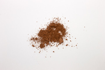 This is a photograph of a Matte Brown Powder Eyeshadow isolated on a White Background