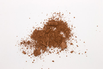 This is a photograph of a Matte Brown Powder Eyeshadow isolated on a White Background