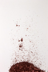 This is a photograph of a Burgundy Powder Eyeshadow isolated on a White Background