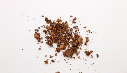 This is a photograph of a Metallic Bronze Powder Eyeshadow isolated on a White Background