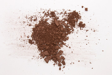 This is a photograph of a Dark Brown Powder Eyeshadow isolated on a White Background