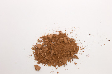 This is a photograph of a Brown Powder Eyeshadow isolated on a White Background