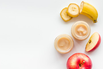 Fruity baby food with apple and banana on white background top view copy space