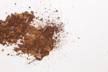 This is a photograph of Brown Powder Eyeshadow isolated on a White Background