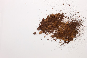 This is a photograph of Brown Powder Eyeshadow isolated on a White Background