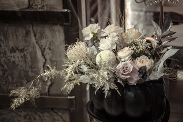 Flower arrangement of fresh flowers in a pumpkin.