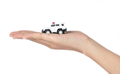 Hand holding Police Car Toys isolated on a white background.