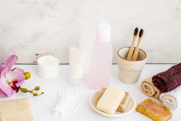 Bathroom accessories set with tooth brushes and towels on white background