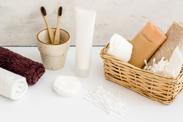 Bathroom accessories set with tooth brushes and towels on white background