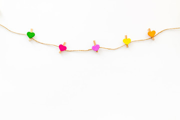 Garland with heart icons on white background top view copy space