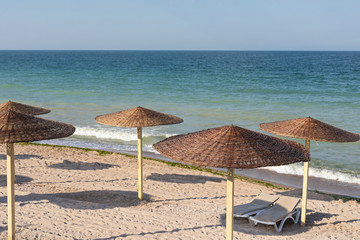 Colorful sunbeds and umbrellas at the beach