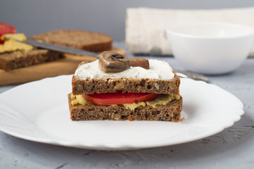 Vegetarian tomato and mushroom Burger with hummus paste.