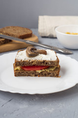 Vegetarian tomato and mushroom Burger with hummus paste.