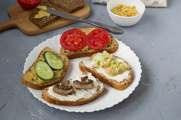 Vegetarian sandwich with tomato, mushrooms, cucumber, cauliflower and hummus.