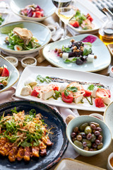 Variety of dishes on the table. Various snacks and antipasti on the table. Restaurant menu. Italian cuisine