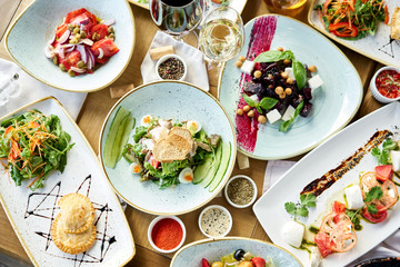 Variety of dishes on the table. Various snacks and antipasti on the table. Restaurant menu. Italian cuisine