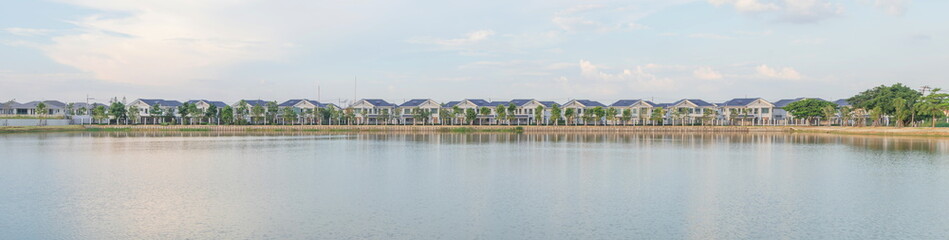 Panorama tropical view of New home or residential building under construction locate nearly lake with blue sky and sunlight in the evening time.