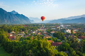 Fotobehang Hot air balloon over Nam Song river at sunrise in Vang vieng, Laos. Asia. © Curioso.Photography